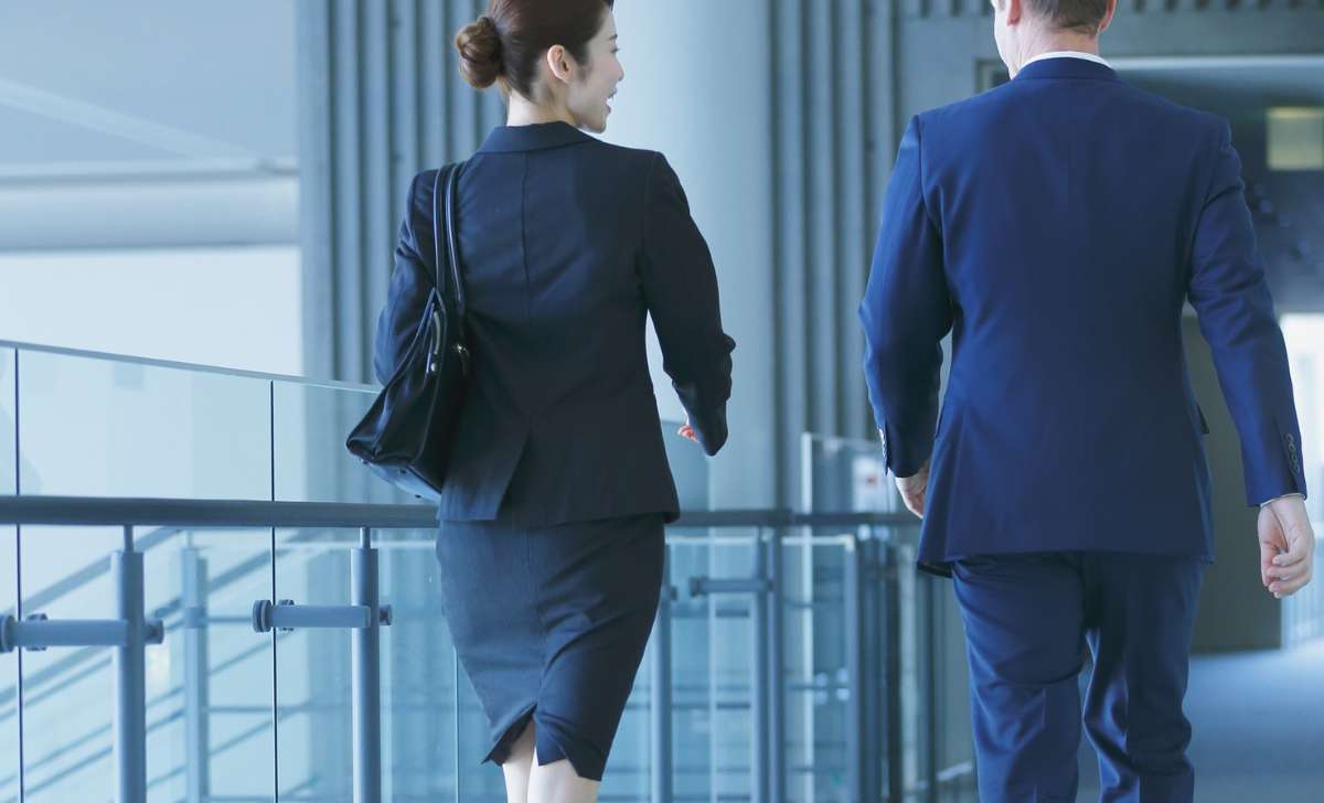 Professional business setting with two people reviewing company documents and legal papers, symbolizing hidden ownership risks and compliance issues in Thailand.